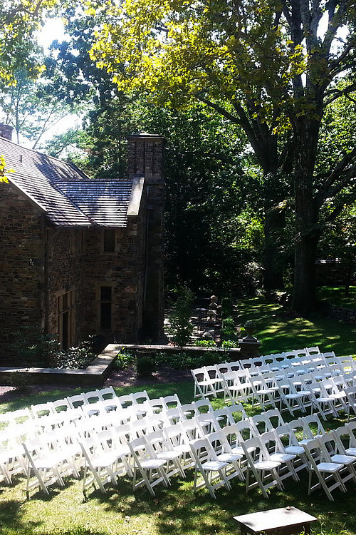 Image of Ceremony with White Padded Chairs