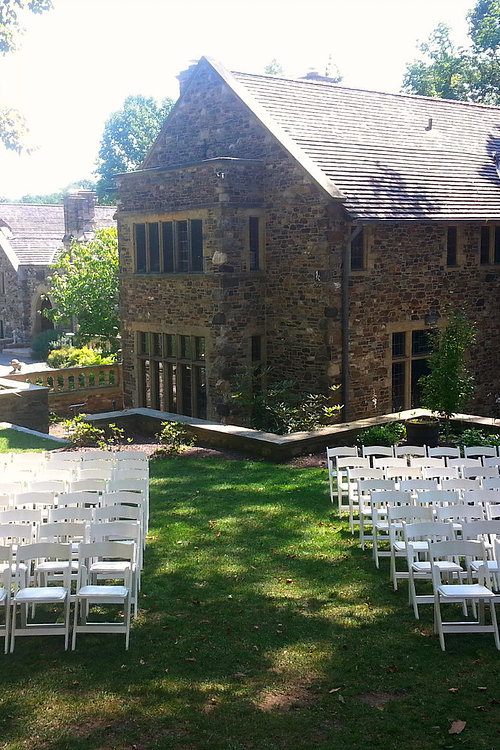 Image of Ceremony with White padded chairs