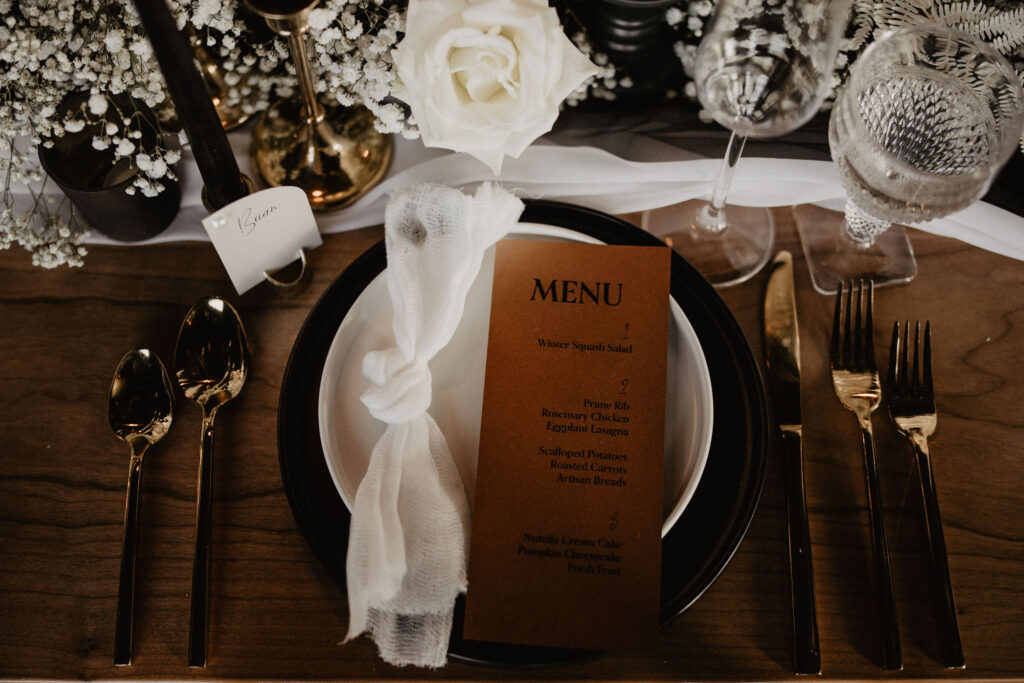 image of place setting with black and white stoneware and primrose flatware