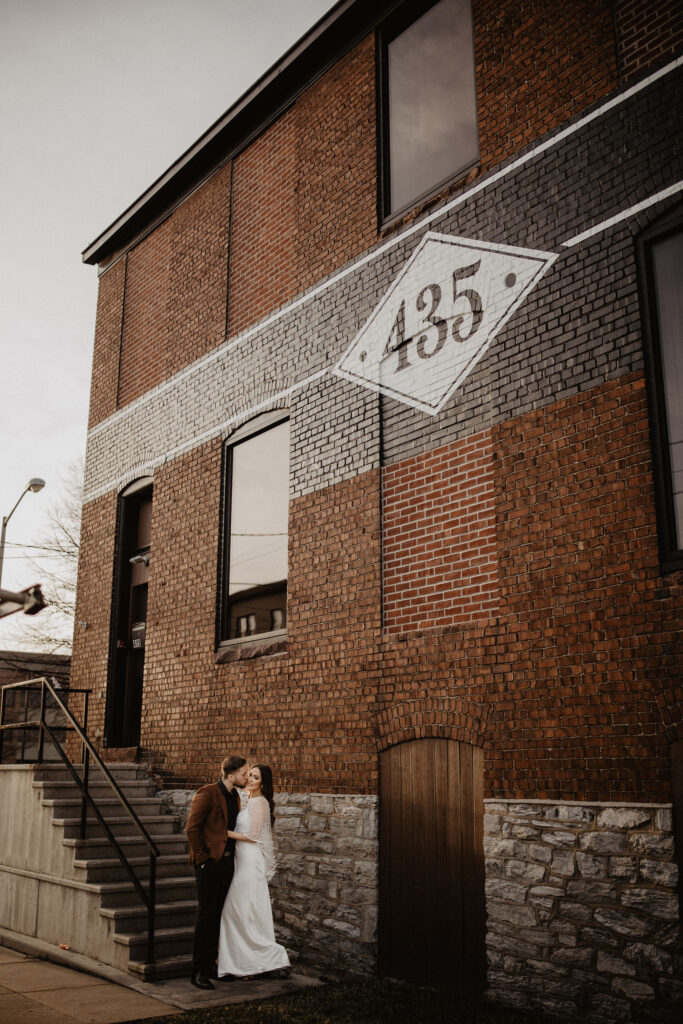 Image of couple standing in front of warehouse 435