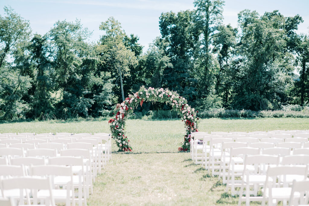 image of gold circle wedding arch covered in florals