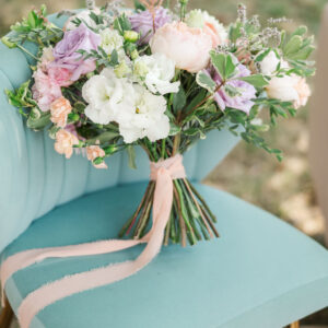 image of sage greta lounge chair rental with flowers