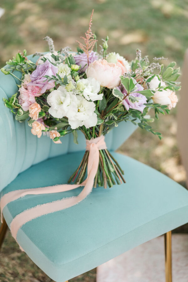 image of sage greta lounge chair rental with flowers