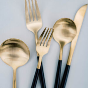 image of black and gold anemone flatware rental