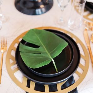 Image of black and gold dinnerware rental