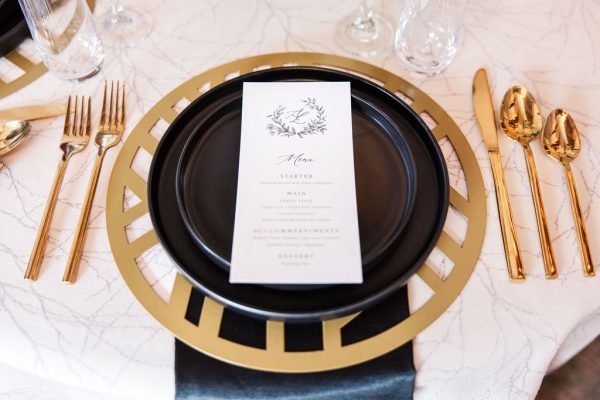 image of black and gold dinnerware rentals