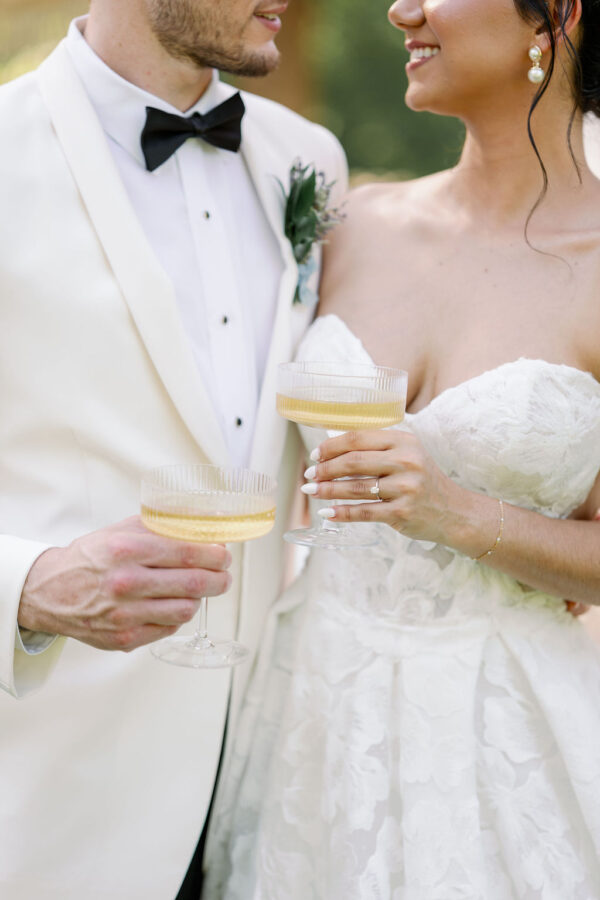 image of fluted champagne coupe rentals with bride and groom