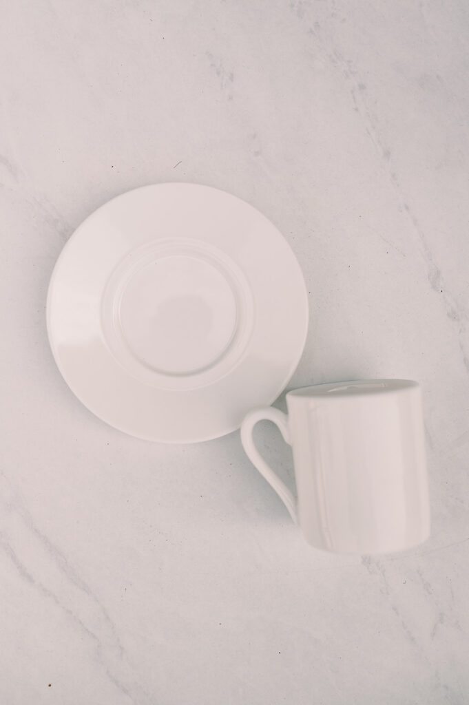 white saucer plate with white coffee mug