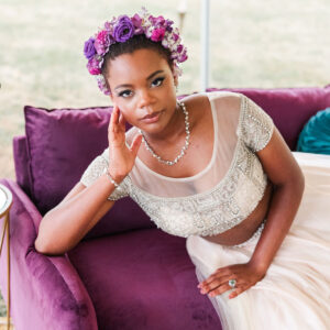 image of bride sitting on purple loveseat