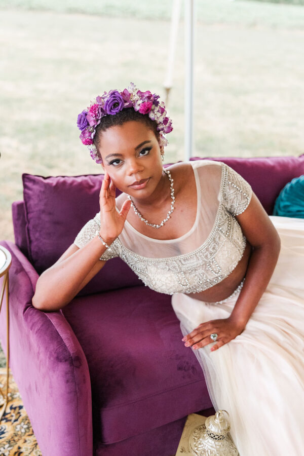 image of bride sitting on purple loveseat