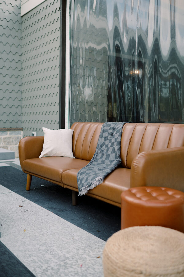 Image of brown leather sofa rental staged for events