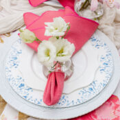 image of blue dinnerware rentals on floral linen