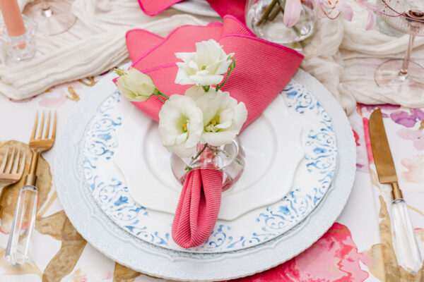 image of blue dinnerware rentals on floral linen