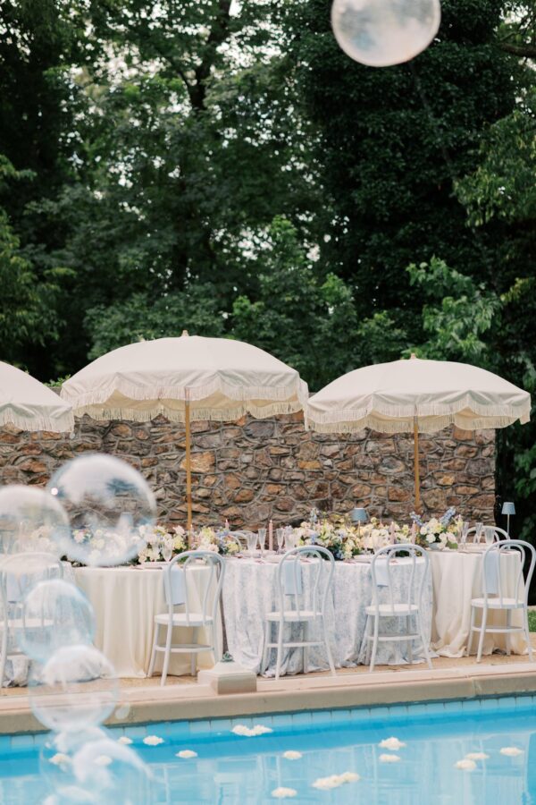 image of tan sun umbrellas set up by a pool