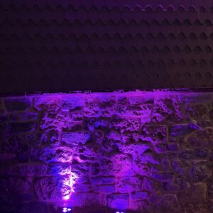 image of uplighting rentals set against a stone wall