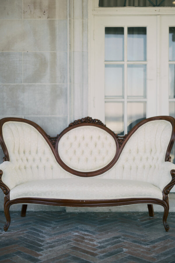 White vintage loveseat with floral pattern