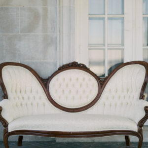 White vintage loveseat with floral pattern