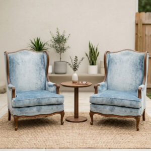 two light blue velvet accent chairs arranged in a conversational setting.