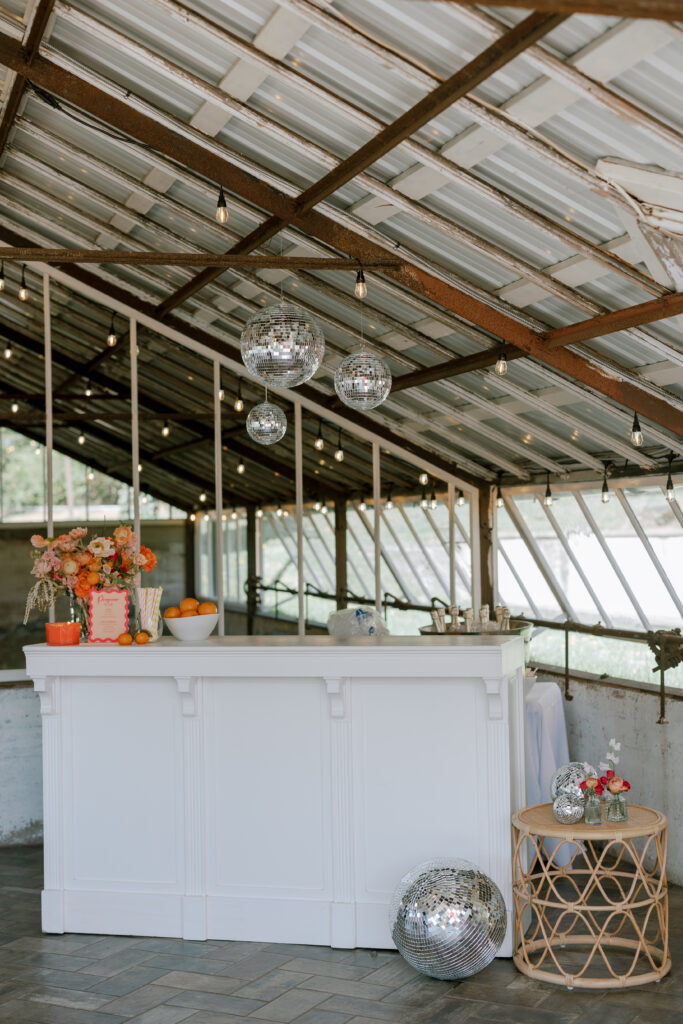 White Caroline bar with disco ball decor and bar top decor