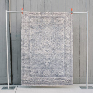 image of bluebell rug staged against a wooden wall