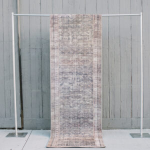 image of Evelyn rug runner staged against a grey barn wall
