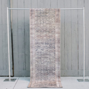 image of Evelyn rug runner staged against a grey barn wall