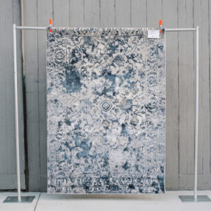 image of Newton rug staged against a wooden wall