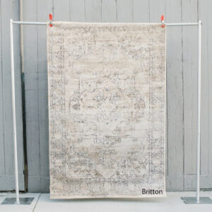 image of Britton rug staged against a wooden wall