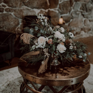 Modern gold metal coffee table with flower arrangement.