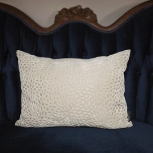 Small, off white pillow, with decorative petals.