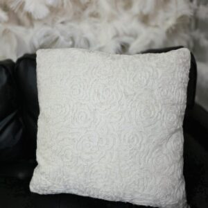 White pillow with white rose floral designs