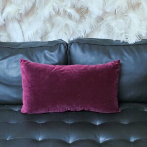 Small, elongated purple velvet throw pillow