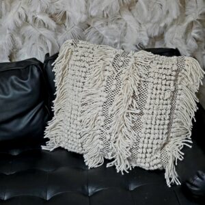 Large white pillow with fringe.
