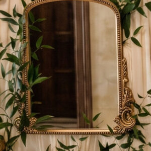 Gold squoval mirror with embellishments on the side