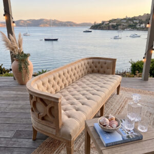AI generated image of the Marisa sofa rental styled at a coastal reception setting.