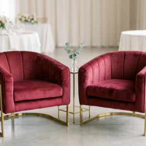 AI generated image of 2 ruby rental accent chairs staged in a reception area during cocktail hour.